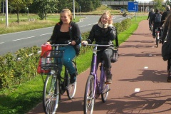 Two girls riding alongside each other and chatting as they travel